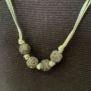 Necklace, carved beads, light green cord, 29.5”.  Looks great against black.